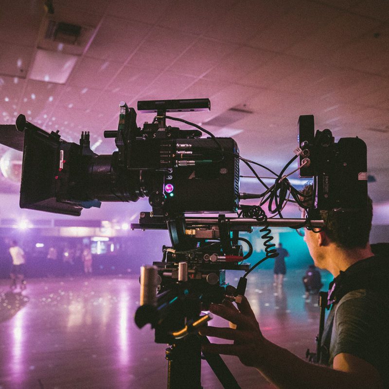Cameraman filming with steadycam in a roller disco