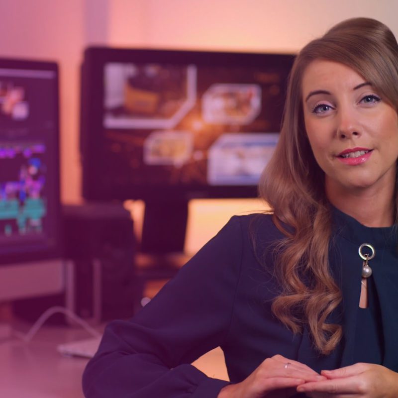 Woman in front of two monitors