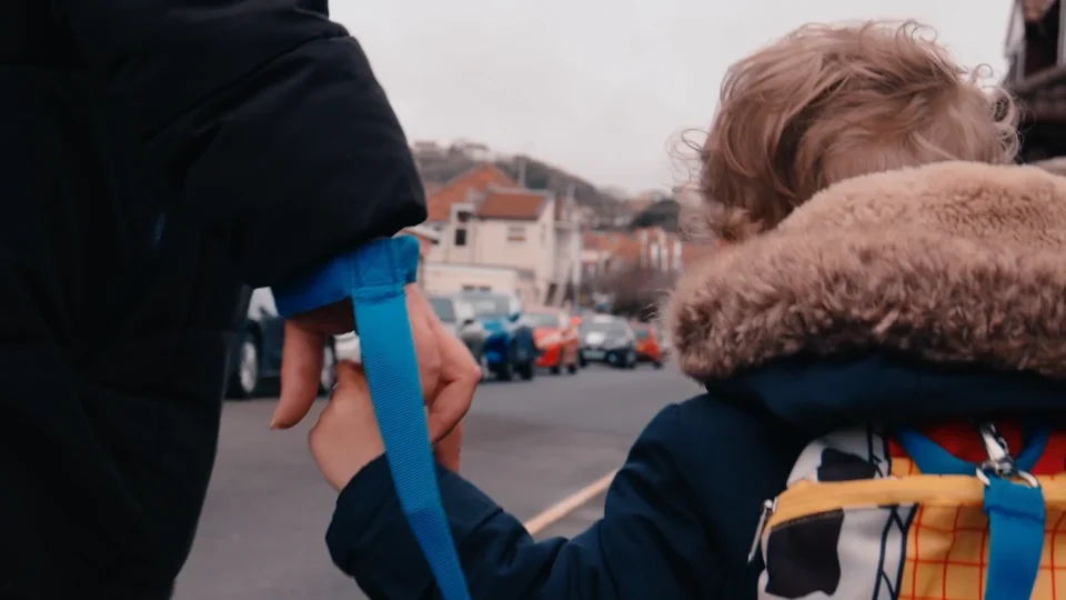 Child & adult holding hands